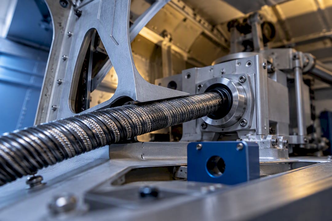 Wound flexible shaft routed inside aerospace structure